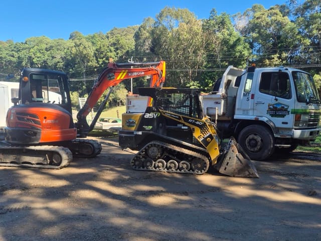 Dirt Werks Kubota U55-4 excavator, ASV RT-60 posi-track and Fuso Fighter tipper parked side by side